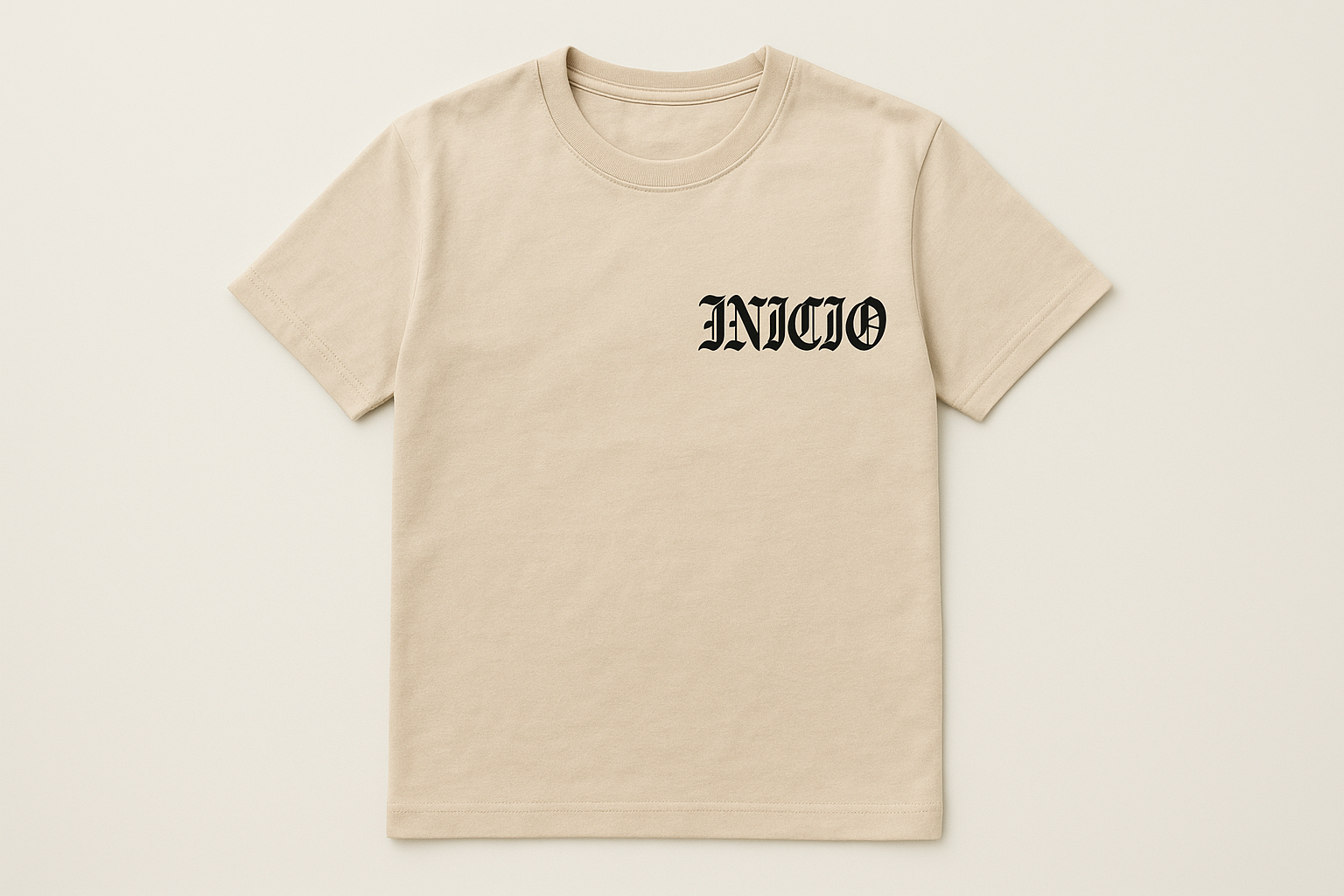 Light tan t-shirt with black INICIO logo - flat lay